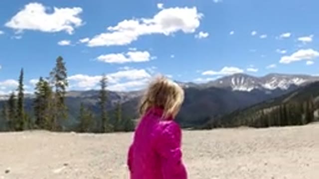 WINTER PARK COLORADO-2019: Girl In A Pink Jacket Walking On The Top Of