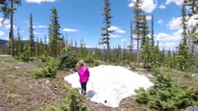 WINTER PARK COLORADO-2019: Little Girl Playing Outside With A Stick In The