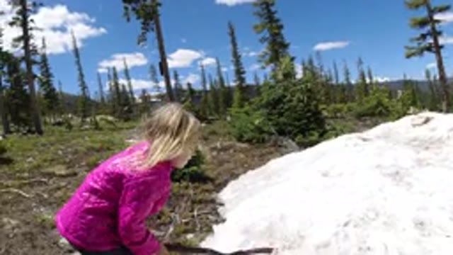 WINTER PARK COLORADO-2019: Little Girl Hitting A Stick On Solid Formation Of Rock