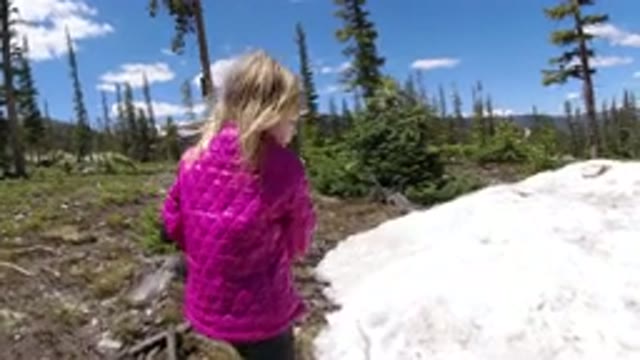 WINTER PARK COLORADO-2019: Child In A Pink Jacket Using A Stick To Play In Snow