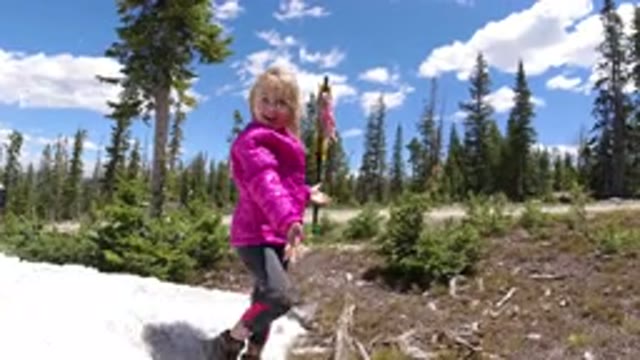 WINTER PARK COLORADO-2019: Little Girl Playfully Throwing Snowballs In The Forest