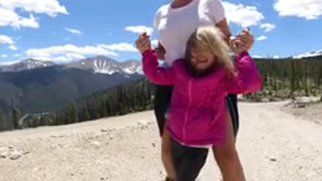 WINTER PARK COLORADO-2019: Mother And Daughter Playfully Walking Through The