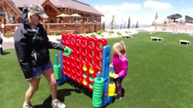 WINTER PARK COLORADO-2019: Mother And Daughter Play Connect Four In Park Nearby