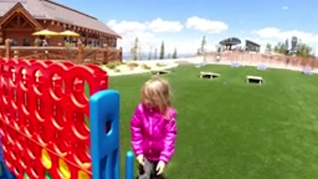 WINTER PARK COLORADO-2019: A Young Girl in a Pink Jacket Plays an Outdoor Game