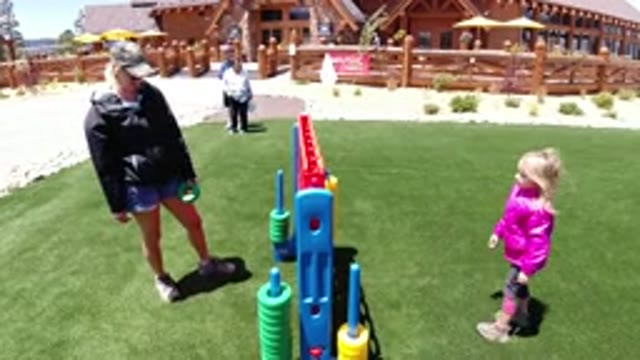 WINTER PARK COLORADO-2019: Little Girl Playing A Game With Dad On Saturday