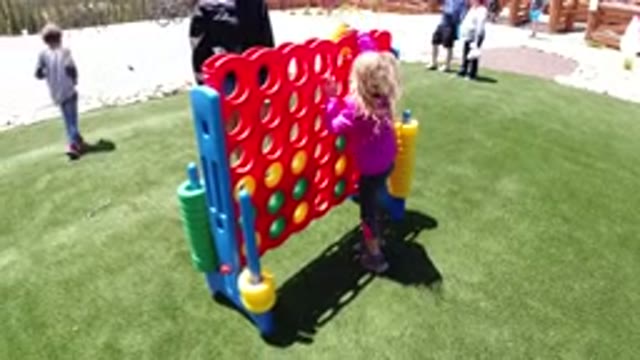 WINTER PARK COLORADO-2019: A Young Girl In A Purple Jacket Plays A Large Version