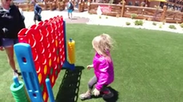 WINTER PARK COLORADO-2019: Girl Wearing A Pink Jacket Is Playing Outside On A