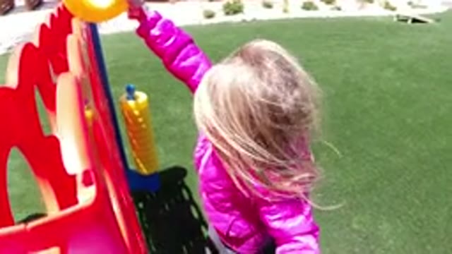 WINTER PARK COLORADO-2019: Little Girl Plays Connect Four at Park During Sunny Day