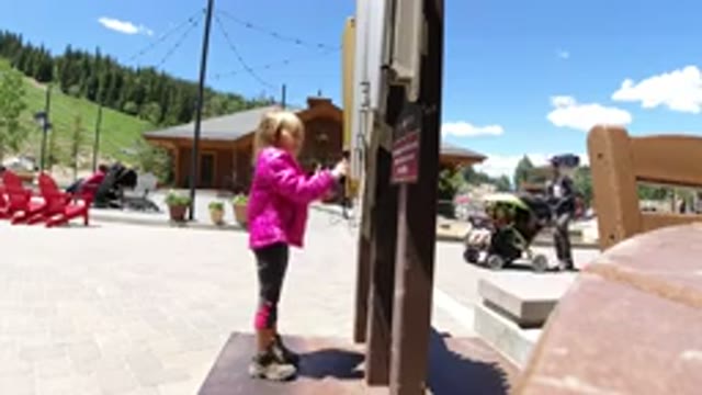 WINTER PARK COLORADO-2019: Little Blonde Girl Having Fun Playing in Public