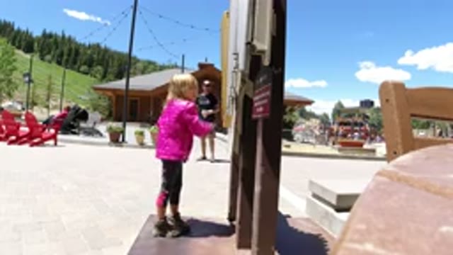 WINTER PARK COLORADO-2019: A Girl At A Beach Tries To Untie Knots Attached To A