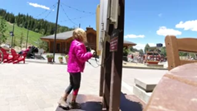 WINTER PARK COLORADO-2019: A Little Girl Hitting On The Wall Or Iron With A Stick