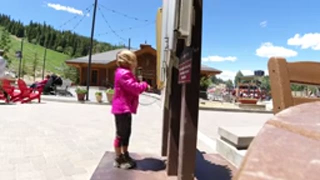WINTER PARK COLORADO-2019: Little Girl Playing With An Old Phone On A Dirt Road