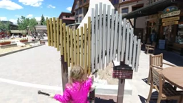 WINTER PARK COLORADO-2019: Child In Pink Jacket Playing At Community Music Event