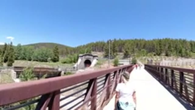 WINTER PARK COLORADO-2019: A Lady Tourist Crossing The Bridge With A Great View