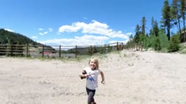 WINTER PARK COLORADO-2019: Young Girl Throws Object in Sunlit Play