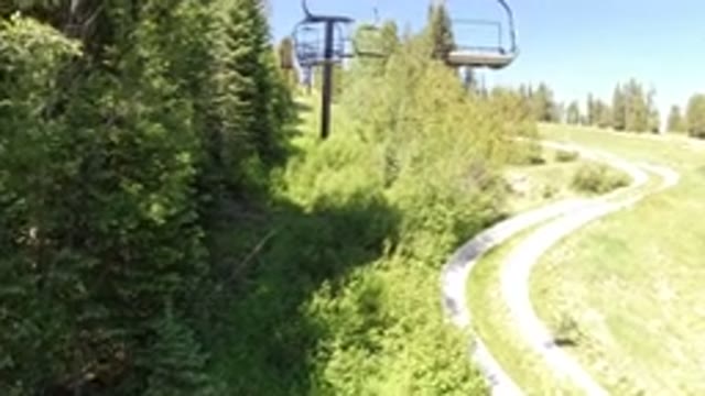 WINTER PARK COLORADO-2019: Air Cart Soaring Across The Sky Over The Trees And Grass