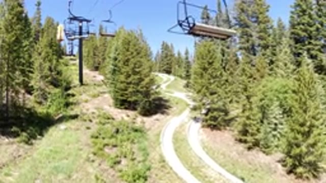 WINTER PARK COLORADO-2019: Ski Lift View Of The Ascent Up The Forested Hillside