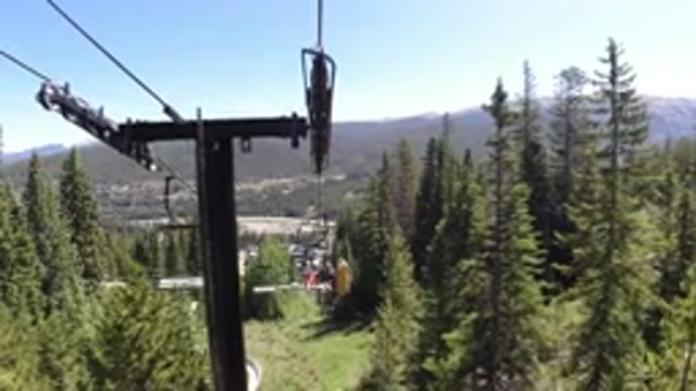 WINTER PARK COLORADO-2019: A View From A Rope Way Seat Moving In The Middle Of A Pine Valley