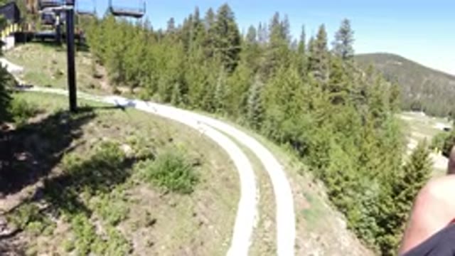 WINTER PARK COLORADO-2019: Riding On An Empty Chairlift Over A Wooded Path In