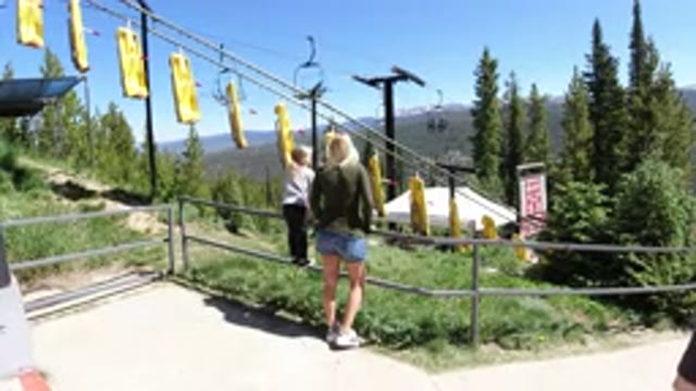 WINTER PARK COLORADO-2019: A Small Girl And A Young Lady Standing In A Park