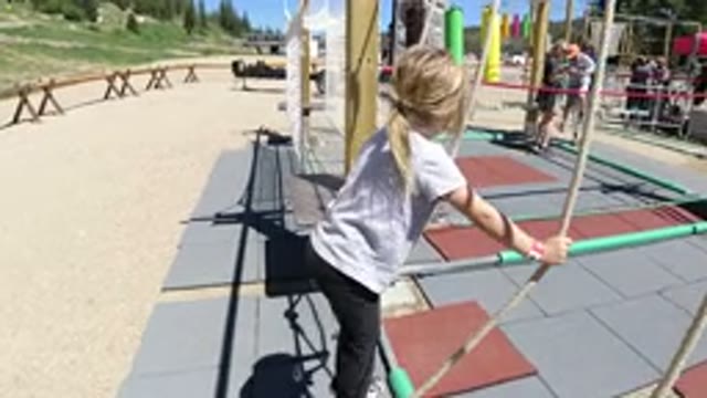 WINTER PARK COLORADO-2019: Girl Plays On Rope Swing At Summer Assault Course