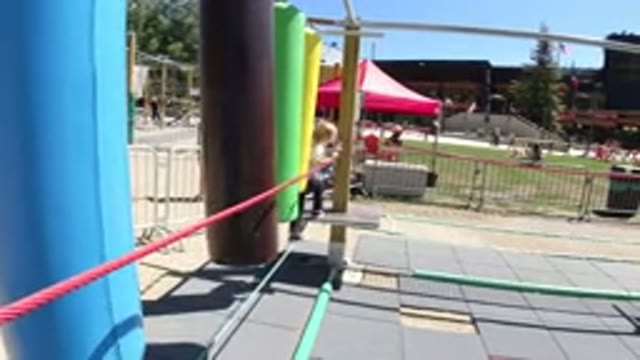WINTER PARK COLORADO-2019: Young Girl Climbing On Colorful Playground Agility