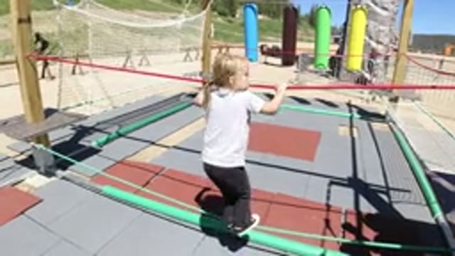 WINTER PARK COLORADO-2019: Little Girl Playing and Balancing on Two Sets of Rope