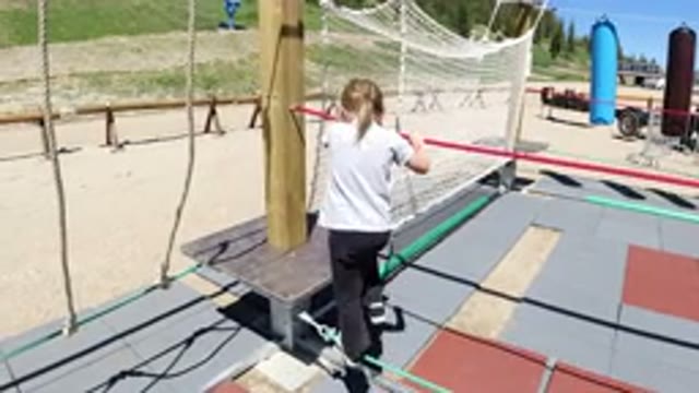 WINTER PARK COLORADO-2019: Little Girl Playing on Playground Jumping and Walking