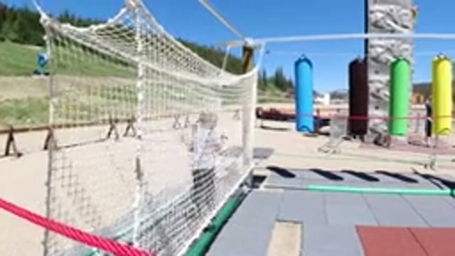 WINTER PARK COLORADO-2019: Child Playing In A Net In A Playground Surrounded By