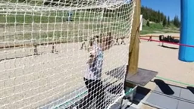 WINTER PARK COLORADO-2019: Young Girl Playing On A Jungle Gym Climbing On A Net