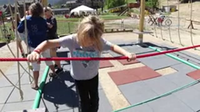 WINTER PARK COLORADO-2019: A Little Girl Tight Roping On The Ground At A Playground