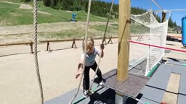 WINTER PARK COLORADO-2019: Child Playing With Rope Activity On Playground