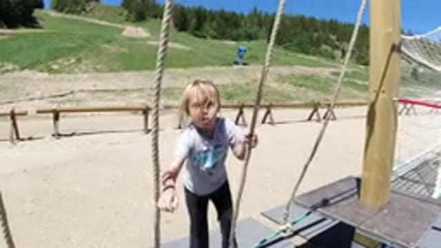 WINTER PARK COLORADO-2019: Little Girl Playing With Rope Course On Playground On