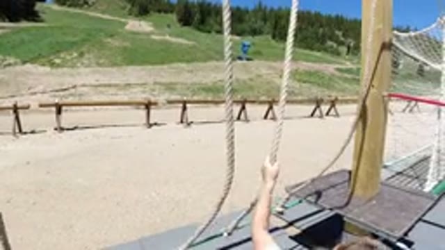 WINTER PARK COLORADO-2019: A Small Girl Jumping From a Rope Swing and Climbing