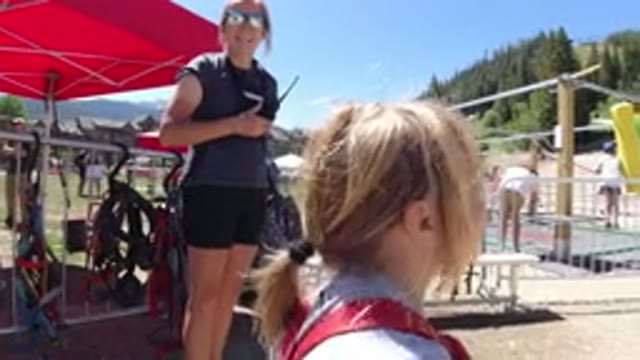 WINTER PARK COLORADO-2019: A Little Girl in Overalls Talking at the Park