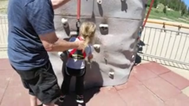 WINTER PARK COLORADO-2019: An Adult Is Teaching A Kid How To Rock Climb On A