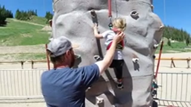 WINTER PARK COLORADO-2019: A Man In Blue Shirt Helping A Little Girl
