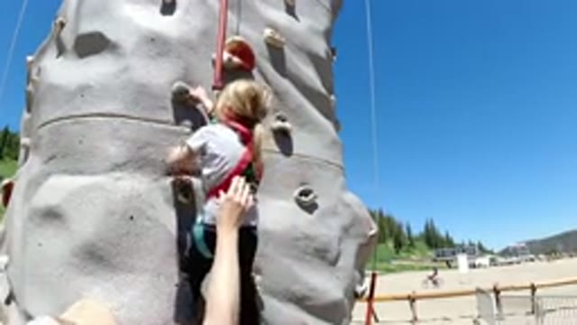 WINTER PARK COLORADO-2019: Girl Doing Rock Climbing In The Daylight Against A