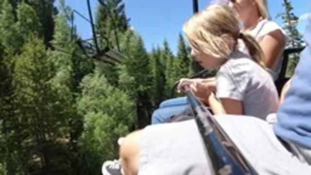 WINTER PARK COLORADO-2019: A Family Moving Forward On A Ropeway Seat Over A Pine