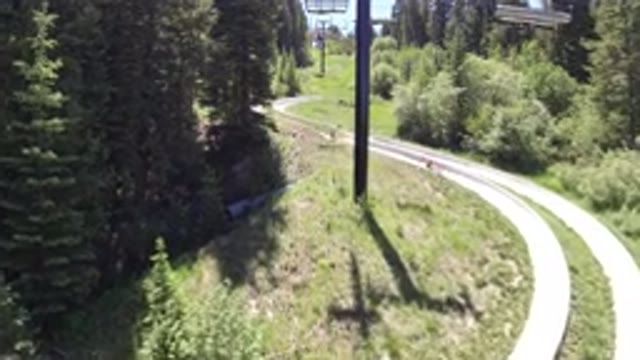 WINTER PARK COLORADO-2019: A Go-Kart Track Has Two People Sliding Down Behind