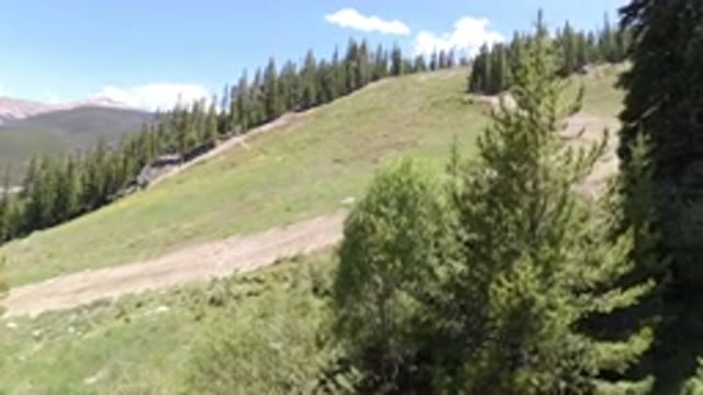 WINTER PARK COLORADO-2019: View Of A Winding Dirt Road Up A Mountain Covered