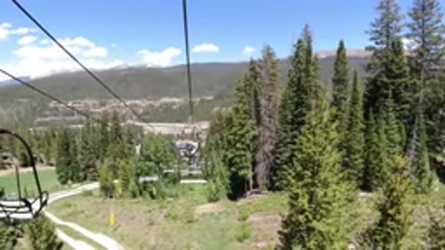 WINTER PARK COLORADO-2019: Air Cable Car Glides Across Woody Area With Child