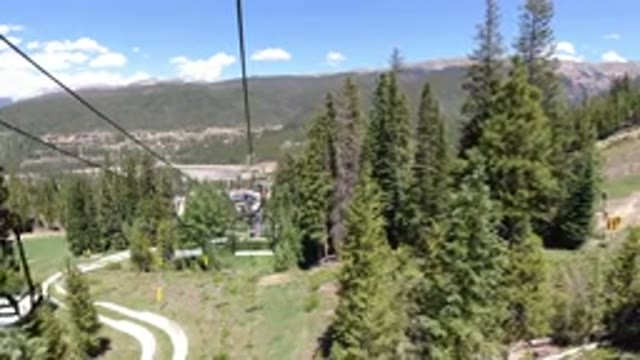 WINTER PARK COLORADO-2019: An Unenclosed Cable Lift Runs Up A Mountain And Over