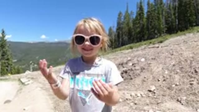 WINTER PARK COLORADO-2019: A Kid Wearing A Sunglass Is Covering Her Eyes With
