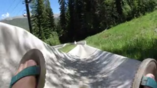 WINTER PARK COLORADO-2019: Sandal-Toed Guy And Another Sliding Down A Lush Field