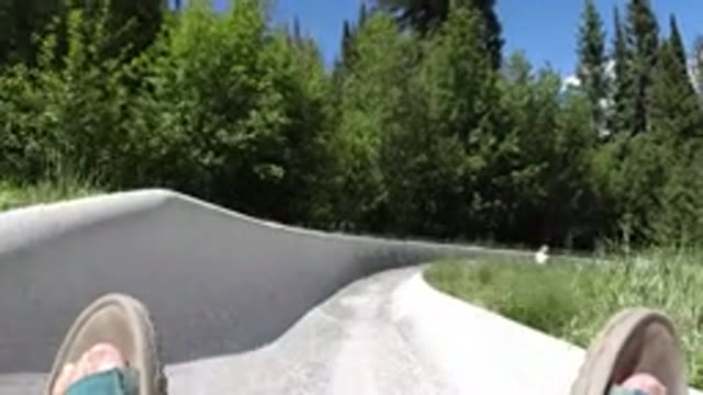 WINTER PARK COLORADO-2019: Person Sliding Down Long Concrete Attraction Slide