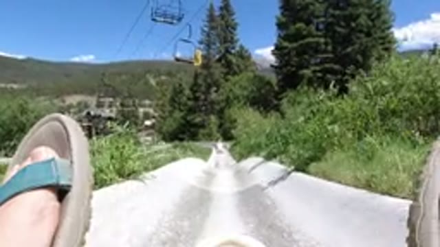 WINTER PARK COLORADO-2019: A Person Sliding Down a Concrete Ramp with Blue Shoes
