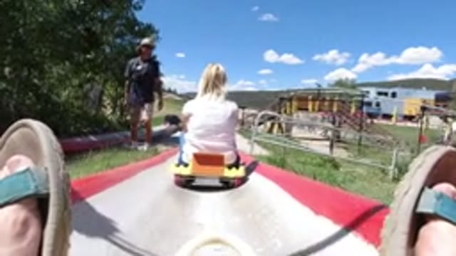 WINTER PARK COLORADO-2019: Two People Are Sliding Down A Concrete Ramp On A