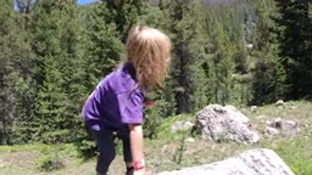 WINTER PARK COLORADO-2019: Child Climbing On Rock In Nature
