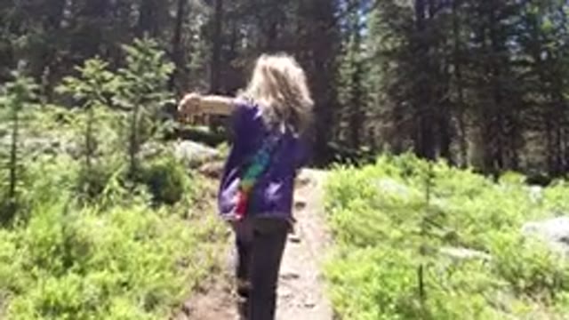 WINTER PARK COLORADO-2019: Little Girl And Unidentified Guardian Exploring The Woods